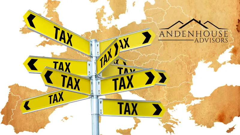 A yellow multi-directional signpost with arrows pointing in every direction reading 'TAX', set against a vintage map background of Europe with the black Andenhouse Advisors logo in the top right corner.